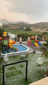 a pool with a bunch of playground equipment at Golden White Hotel in Taif