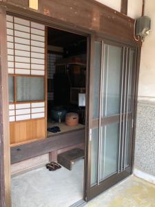 an entrance to a room with glass doors at 古月(KozukI)久年庵 in Yamaguchi