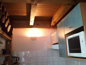 a kitchen with a microwave and a counter top at Studio 6 pers. avec balcon - Studio 6 personnes MAE-9483 in Barèges +12 photos