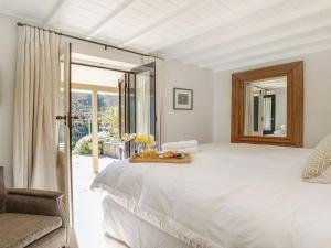 a bedroom with a large white bed and a mirror at Protestant Hall in Wildes Meadow