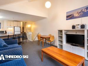 a living room with a couch and a table at Kirkwood 4 in Thredbo