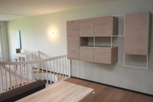 a room with a staircase with a book shelf at Fewo-Suite "Horizonte I" in Ascheberg