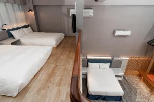 Postel nebo postele na pokoji v ubytování Fu Hsiang Hotel