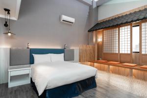 Postel nebo postele na pokoji v ubytování Fu Hsiang Hotel
