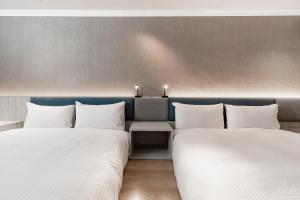 Postel nebo postele na pokoji v ubytování Fu Hsiang Hotel