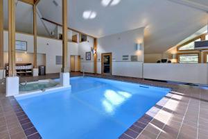 a large blue swimming pool in a house at Trail Creek 05 in Killington