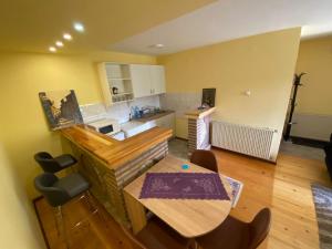 a kitchen with a table and a dining room at Apartman Mijovic - Nova Varos in Nova Varoš