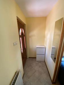 a room with a hallway with a bed and a mirror at Apartman Mijovic - Nova Varos in Nova Varoš