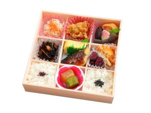 a bento box filled with rice and different types of food at Sunrise Suites in Kyoto