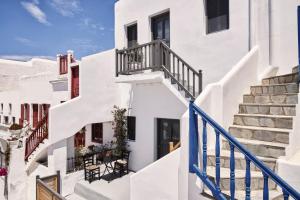 a group of white buildings with stairs at Maison Central in Mýkonos City