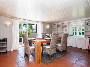 a dining room with a wooden table and chairs at Ferienhaus REETselig mit Pool Sauna in Klein Barkau
