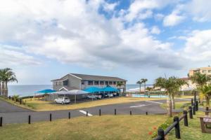 a view of a building with the ocean in the background at 3 Eden Sands in Kingsburgh
