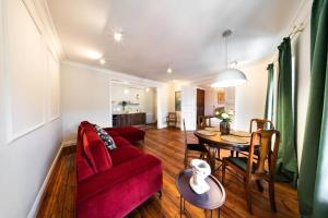 Una sala de estar con un sofá rojo y una mesa. en Old Town Prosta Toruń, en Toruń