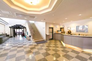 a lobby with a staircase and a lobbyasteryasteryasteryasteryasteryasteryasteryastery at Kishutetsudo Karuizawa Hotel in Tsumagoi