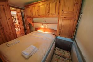 a small bed in a room with wooden cabinets at Apartment Beauregard in Les Houches