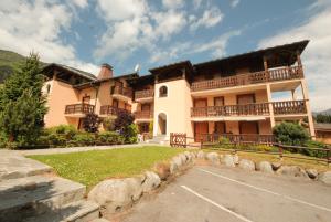 a large house with a parking lot in front of it at Apartment Beauregard in Les Houches