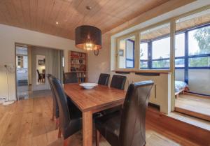 a dining room with a wooden table and chairs at Gaillands North in Chamonix