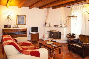 a living room with a couch and a fireplace at Vacation home in the Archanes with balcony in Archanes