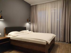 Posteľ alebo postele v izbe v ubytovaní Chopin Apartments - City