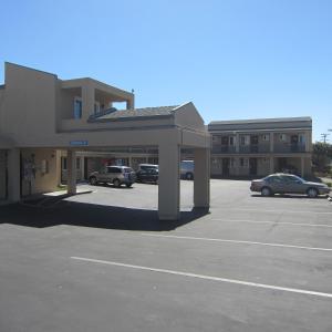 un edificio con coches estacionados en un estacionamiento en Pacific Best Inn, en Seaside