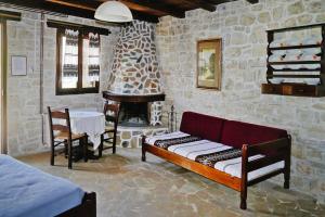 a room with a couch and a table and a fireplace at Apartment with Paid Sauna in Balíon