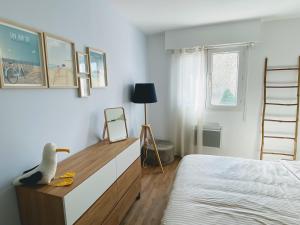 Un dormitorio con una cama y un escritorio con un pato de juguete. en Le Pontappart, en Royan