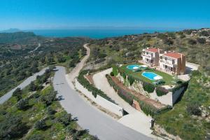 an aerial view of a house on a hill with a road at Welcoming villa in Triopetra with pool in Triopetra