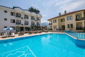 a large swimming pool in front of two buildings at Kilim Hotel & Apart in Fethiye
