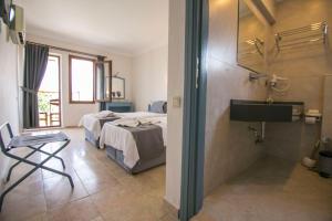 a hotel room with two beds and a sink at Kilim Hotel & Apart in Fethiye