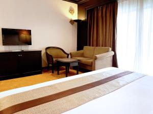Voodi või voodid majutusasutuse Grand Darul Makmur Hotel Kuantan toas