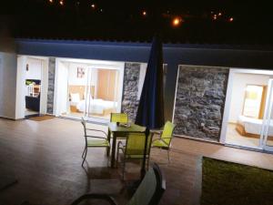 a room with a table and chairs and a bedroom at CASA SOL E VISTA 2 in Arco da Calheta