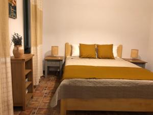 a bedroom with a bed with two night stands and two tables at Grauri si Smochini in Vadu