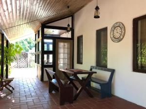 a dining room with a table and a clock on the wall at Grauri si Smochini in Vadu