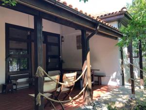 a patio with a hammock on a house at Grauri si Smochini in Vadu +18 photos