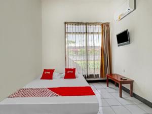 Ένα ή περισσότερα κρεβάτια σε δωμάτιο στο OYO 90621 Pondok 23