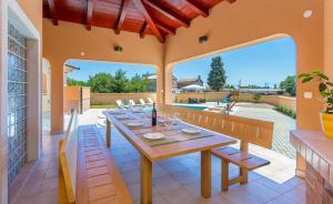 a dining room with a table and chairs and a patio at Pool Terrace Relax & Fun Villa Fuma in Loborika