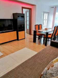 a living room with a table and a dining room at Lend apartment in Miercurea-Ciuc