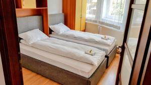 two beds in a room with a mirror at Lend apartment in Miercurea-Ciuc