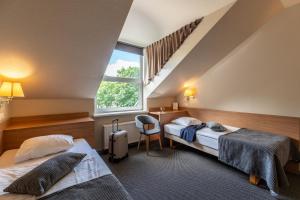 Postel nebo postele na pokoji v ubytování Hotel Sigulda