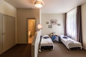Postel nebo postele na pokoji v ubytování Hotel Sigulda