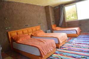 Postel nebo postele na pokoji v ubytování Riad Dar Tagine