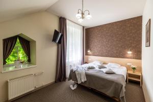 Postel nebo postele na pokoji v ubytování Hotel Sigulda