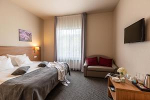 Postel nebo postele na pokoji v ubytování Hotel Sigulda