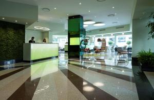 a lobby with a man standing at a counter at c-hotels Concorde in Milan