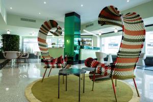 a lobby with two chairs and a table at Antares Hotel Concorde, BW Signature Collection by Best Western in Milan