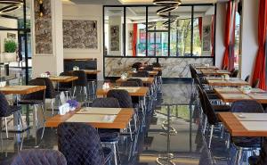 a row of tables and chairs in a restaurant at BURSA KOZA HOTEL in Bursa