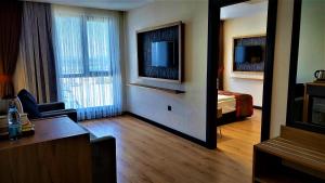 a hotel room with a bedroom with a bed and a mirror at BURSA KOZA HOTEL in Bursa