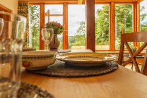 a table with plates and glasses on top of it at Waldhäuschen am Sonnenhof in Kassel