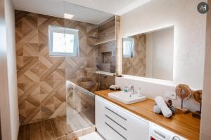 a bathroom with a sink and a mirror at AH Nová Terasa II in Košice +35 photos