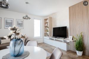 a living room with a television and a table at AH Nová Terasa II in Košice